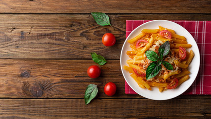 Pasta bolognese with tomato sauce and minced meat, grated parmesan cheese and fresh basil - homemade healthy italian pasta on rustic wooden background. Flat lay. Top view.