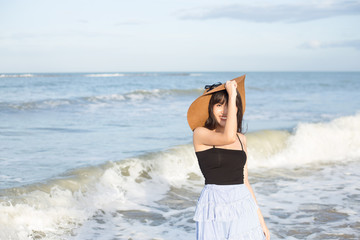 Beautiful girl smiling happily on a sunny day, Hua Hin beach, Thailand