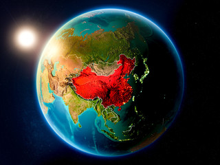 Obraz na płótnie Canvas China with sunset from space