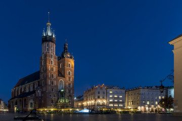 Fototapeta na wymiar Beautiful view of the famous Saint Mary's Church Basilica and the main market square in the historic center of Krakow, Poland in the blue hour light