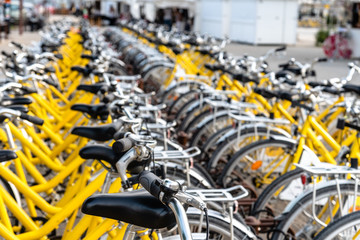 Yellow bicycle rental station on city street