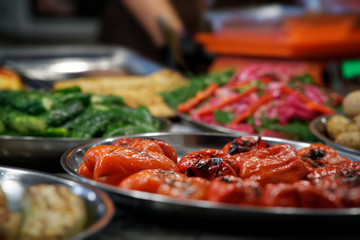 Street food on night outdoor market. Spicy, seafood, veggie, vegetable meal