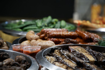 Street food on night outdoor market. Spicy, seafood, veggie, vegetable meal