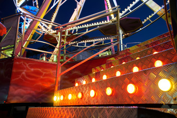 Staircase to Ferris wheel attraction illuminated with colorful lights. - 219385159