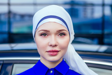 close-up portrait attractive and mysterious Muslim European woman perfect skin and charming eye makeup the head is covered with a handkerchief wearing Hijab