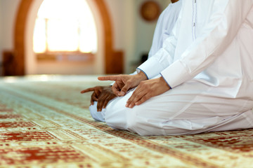 Two religious muslim man praying together inside the mosque © FS-Stock