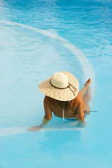 Pretty blonde woman enjoying the swimming pool in Greece