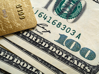 Bank card and one hundred dollar bills, close up