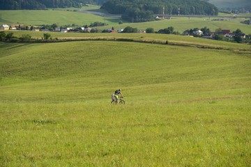 Cyclist on a meadow. Slovakia