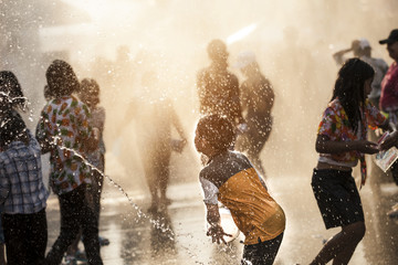 Peaple enjoy water splashing in the street water tunnel in Khao Niew Road, Khon Kaen City during...