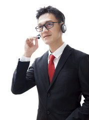 Smiling man in call center with headset isolated on white background. Close-up portrait asian man talk in call center.