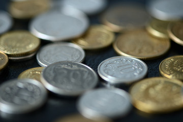Some Polish coins scattered on a dark background close up
