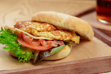 Delicious burger with omelette breakfast dish close up