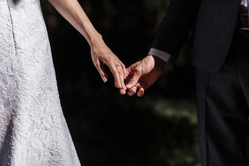  a man and a woman gently hold their hands