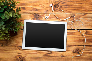 White digital tablet on wooden table