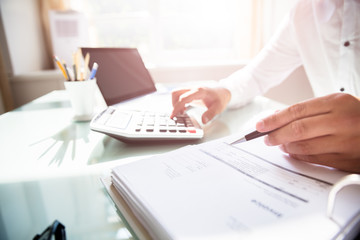 Businessman calculating bill