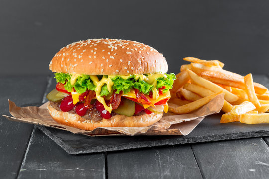 Hamburger with fries on a slate plate - Powered by Adobe