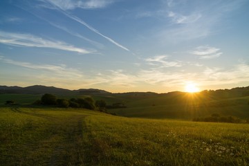Naklejka na ściany i meble Sunrise and sunset over the hills and town. Slovakia