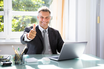 Happy Businessman Gesturing Thumbs Up