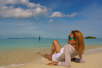 Fototapeta na wymiar Woman resting on her elbows on the beach