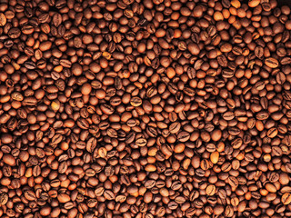 Roasted coffee beans background. Rich brown coffee beans texture. Close-up