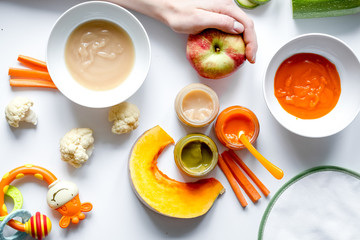 cooking vegetable puree for baby on white background top view