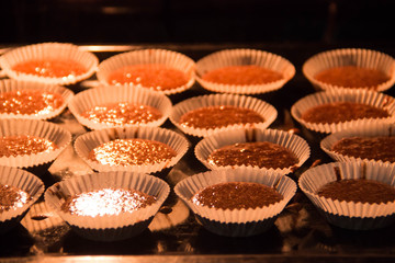 Chocolate muffins are baked in the oven