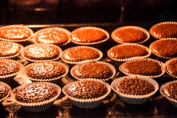 Fototapeta na wymiar Chocolate muffins are baked in the oven
