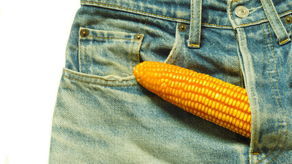 big corn sticks out of mens jeans like mens penis as potency concept