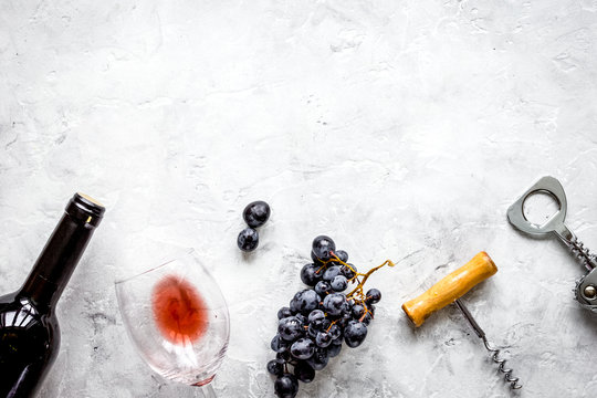 bottle of red wine with glass on texture background top view moc