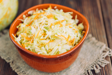 Fresh cabbage and carrots salad on wooden on the table