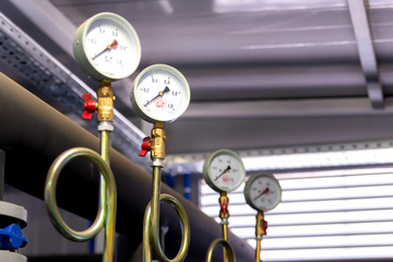 System of hot water pipes with manometer in boiler room
