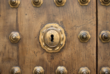 golden keyhole on wooden door