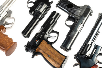 group of isolated black and silver pistols on a white background