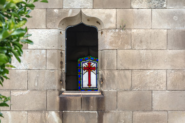 Barcelona, Spain - May 10, 2018: The window of one of the crypts in Poblenou Cemetery. Peaceful but macabre, cemetery of Poblenou is today home to incredible sculptures, haunting, yet beautiful.