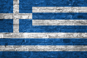 Fototapeta na wymiar Flag of Greece over an old brick wall background, surface