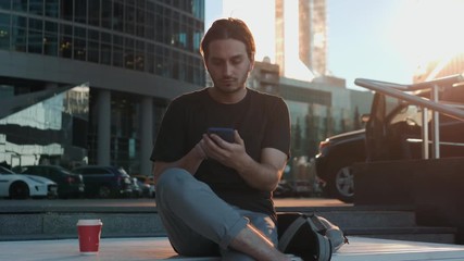 Man voice recognition with smart phone in railway station train public transportation, audio message helper student in university on sunset with coffee stylish happy