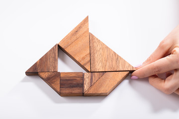 Woman Making Boat With Tangram Puzzle