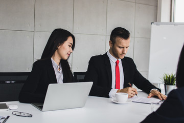 Business people reading clearly before signing on contract in meeting