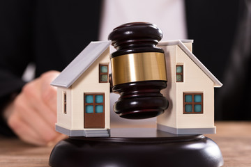 Judge Striking Gavel Between Split House