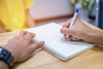 Asian Student note on notebook while learning study and writing for planning work. Studying in Education at university concept. Back to school