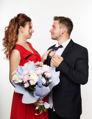 Guy gave a bouquet to a girlfriend on a date. Couple meeting for date on a light background