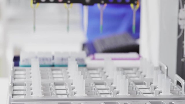 Close-up of the robot in the laboratory injects the drug catalyst for analysis into the test tube