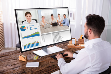 Businessman Video Conferencing With His Colleagues On Computer