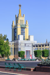 Naklejka premium Pavilion Grain on Exhibition of Achievements of National Economy (VDNH) in Moscow against green trees and blue sky on a sunny summer morning