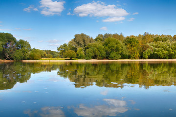 Fototapeta premium Beautiful summer landscape with a lake, trees and blue sky