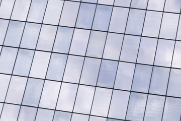 reflection of sky in windows of skyscraper