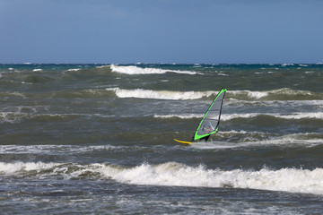 Sea Waves and Wind Surfing in the Summer in Windy Day