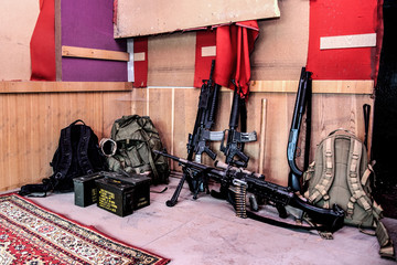 U.S. army marines assault squad weapon storage at outpost with service rifles, combat shotgun,...