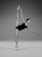 Ballerina in black body and pointes in a string